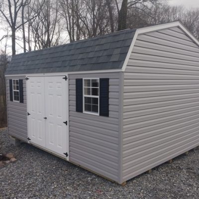 12x16 size vinyl high barn roof style shed with flint siding, white trim, estate gray architectural shingle roof, black shutters. has 8' ridge vent, 6 foot fiber doors and two windows.