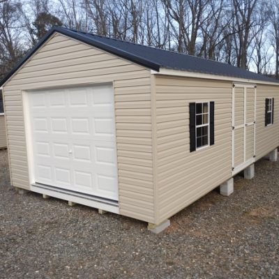 14 x 28 size vinyl a-roof garage style shed with tan siding, white trim, black metal roof, black shutters, 9x7 garage door, 6 foot ggs doors 1' ft taller with two windows.