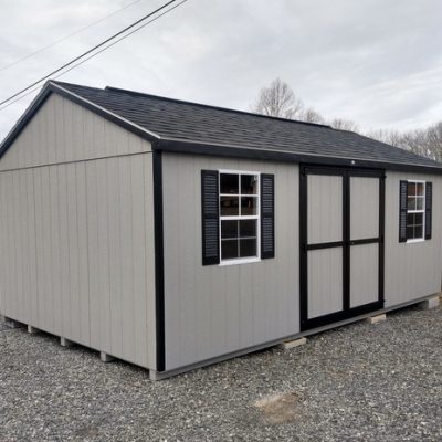 12 x 20 size painted a-roof style shed with gap gray siding, black trim, black architectural shingle roof, black shutters, (2) 8' ridge vents, ggs 6 foot doors, two windows.