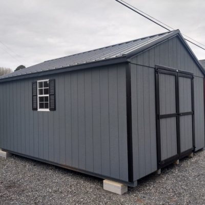 12 x 16 size painted a-roof style shed with gray siding, black trim, black metal roof, black shutters, ggs 6 foot doors, two windows.