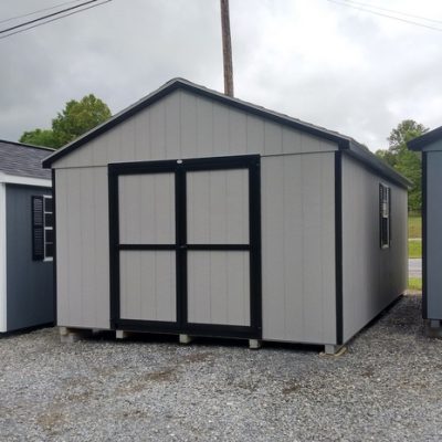 12 x 20 size painted a-roof style shed with gap gray siding, black trim, black architectural shingle roof, black shutters, (2) 8' ridge vents, ggs 6 foot doors, two windows.