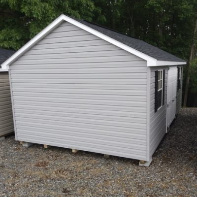 12x20 size vinyl classic roof style shed with flint siding, white trim, black architectural shingle roof, black shutters. has (2) 8' ridge vents, 6 foot fiber doors and two windows.