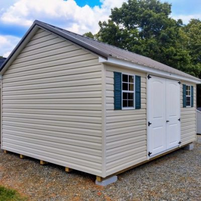 12 x 16 size vinyl classic style shed with mist siding, white trim, burnished slate metal roof, green shutters, fiber 2 plank 6 foot double doors, two windows.