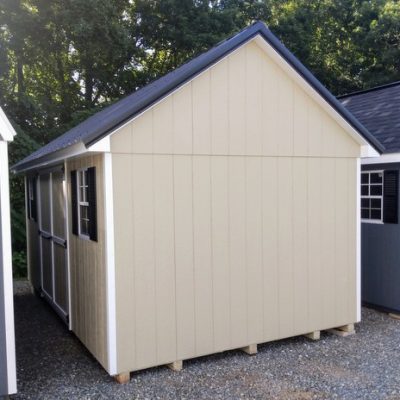 10 x 16 size painted garden style shed with leola almond siding, white trim, black metal roof, black shutters, ggs 6 foot double doors, two windows.