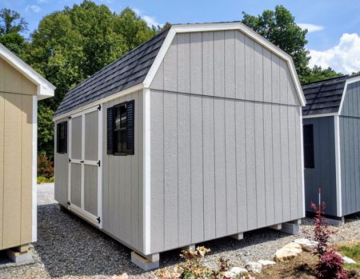 10 x 16 size painted high barn style shed with gap gray siding, white trim, black architectural shingle roof, black shutters, (1) 8' ridge vent, ggs 6 foot double doors, two black windows.