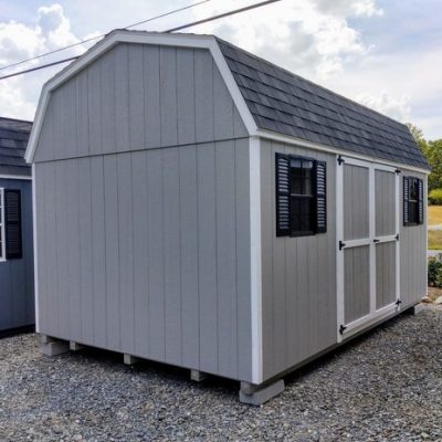 10 x 16 size painted high barn style shed with gap gray siding, white trim, black architectural shingle roof, black shutters, (1) 8' ridge vent, ggs 6 foot double doors, two black windows.