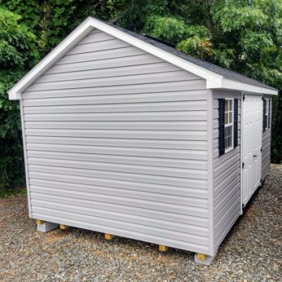 10x16 size vinyl classic roof style shed with flint siding, white trim, black architectural shingle roof, black shutters. has (1) 8' ridge vent, 6 foot fiber double doors and two windows.