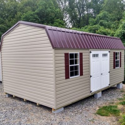 12 x 20 size vinyl high barn style shed with clay siding, clay trim, burgundy metal roof, burgundy shutters, fiber transom 6 foot double doors, two windows.