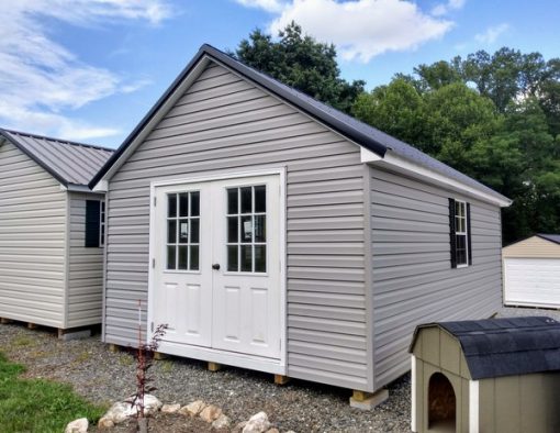 12 x 20 size vinyl garden style shed with flint siding, white trim, black metal roof, black shutters, pre hung 9 lite l.h. outswing 6' double doors 72" tall, two windows.