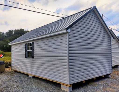 12 x 20 size vinyl garden style shed with flint siding, white trim, black metal roof, black shutters, pre hung 9 lite l.h. outswing 6' double doors 72" tall, two windows.