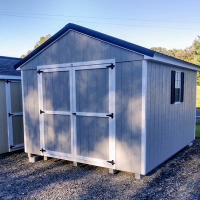 10 x 12 size painted a-roof style shed with gap gray siding, white trim, black metal roof, black shutters, ggs 6 foot doors, two windows.