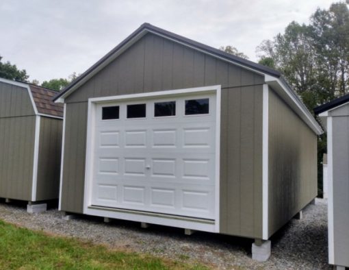 14 x 28 size painted classic garage style shed with clay siding, white trim, burnished slate metal roof, black shutters, garage door with glass, ggs 6 foot double doors 1' ft taller, two windows.