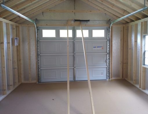 14 x 28 size painted classic garage style shed with clay siding, white trim, burnished slate metal roof, black shutters, garage door with glass, ggs 6 foot double doors 1' ft taller, two windows.