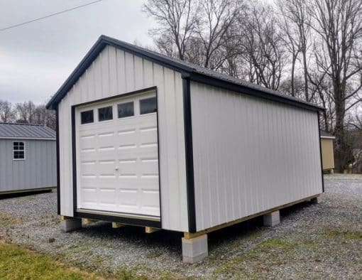 12x20 size metal classic garage style shed with white trim, polar white metal siding, black metal roof, corners and j channel, 8x7 garage door with glass, 3 foot fiber solid shed door with two windows.