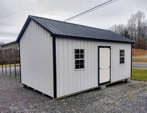 12x20 size metal classic garage style shed with white trim, polar white metal siding, black metal roof, corners and j channel, 8x7 garage door with glass, 3 foot fiber solid shed door with two windows.