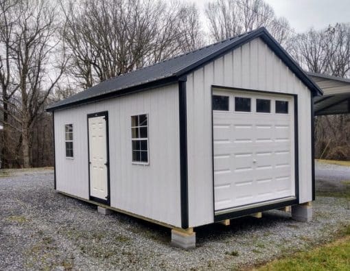 12x20 size metal classic garage style shed with white trim, polar white metal siding, black metal roof, corners and j channel, 8x7 garage door with glass, 3 foot fiber solid shed door with two windows.