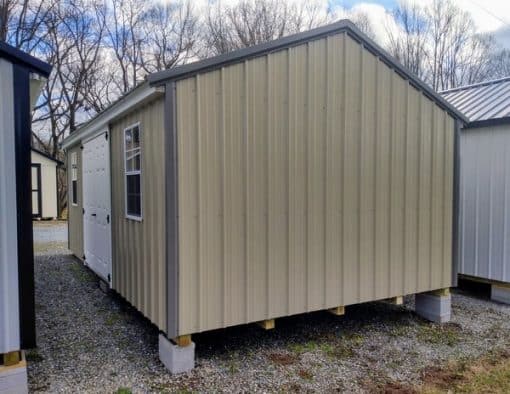 12x20 size metal a-roof style shed with white trim, desert sand metal siding, charcoal metal roof, corners and j channel, 6 foot fiber double shed doors with two windows.