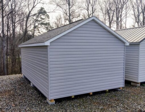 12x20 size vinyl classic roof style shed with flint siding, white trim, black architectural shingle roof, black shutters. has (2) 8' ridge vents, 6 foot fiber double doors and two windows.