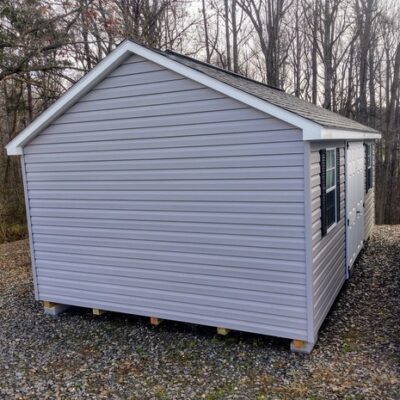 12x20 size vinyl classic roof style shed with flint siding, white trim, black architectural shingle roof, black shutters. has (2) 8' ridge vents, 6 foot fiber double doors and two windows.