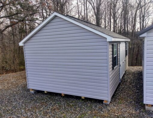 12x20 size vinyl classic roof style shed with flint siding, white trim, black architectural shingle roof, black shutters. has (2) 8' ridge vents, 6 foot fiber double doors and two windows.