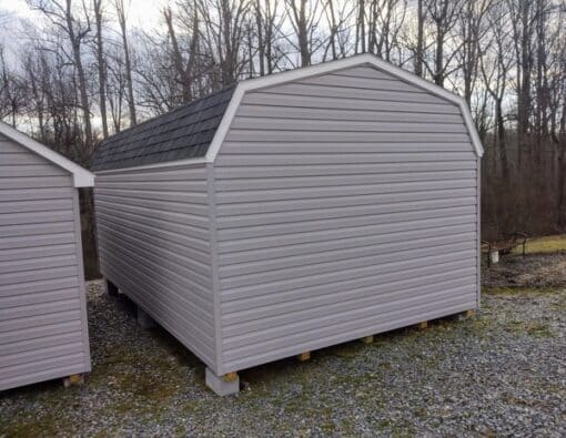 12x20 size vinyl high barn roof style shed with flint siding, white trim, black architectural shingle roof, black shutters. has (2) 8' ridge vents, ggs 6 foot double doors and two windows.