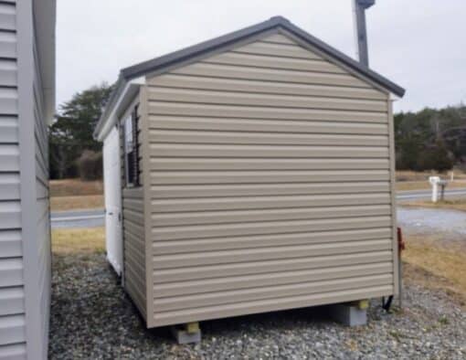 8 x 12 size vinyl a-roof style shed with clay siding, white trim, burnished slate metal roof, burgundy shutters. 6 foot fiber double doors and one window.