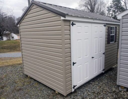 8 x 12 size vinyl a-roof style shed with clay siding, white trim, burnished slate metal roof, burgundy shutters. 6 foot fiber double doors and one window.