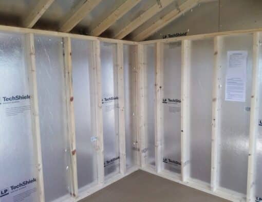 10x12 size vinyl a-roof style shed with flint siding, white trim, black architectural shingle roof, black shutters. has (1) 8' ridge vent, 6 foot fiber doors and two windows.