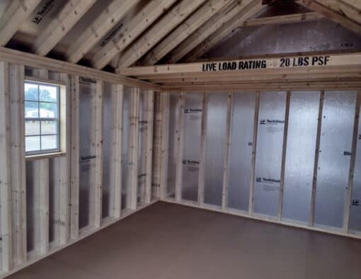 12x16 size vinyl garden roof style shed with clay siding, white trim, brownwood architectural shingle roof, brown shutters. has (1) 8' ridge vent, (1) octagon window, 6 foot fiber doors and two windows.