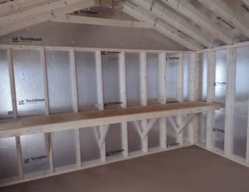 12x16 size vinyl a-roof style shed with almond siding, white trim, estate gray architectural shingle roof, gray shutters. has (1) 8' ridge vent, 6 foot fiber doors and two windows.