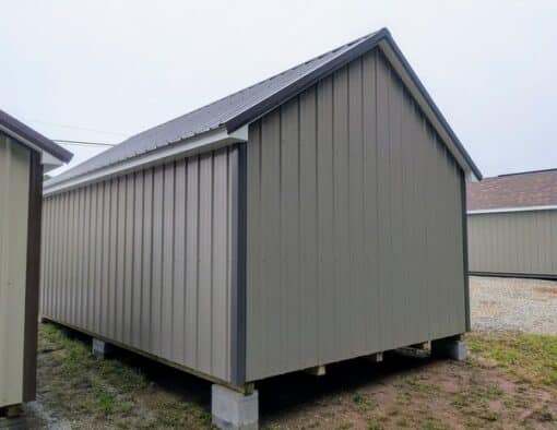 12x20 size metal garden style shed with white trim, taupe metal siding, charcoal metal roof, corners and j channel, 6 foot fiber double shed doors with two windows.