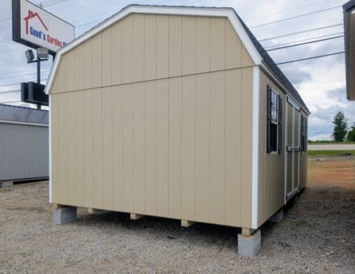 12 x 20 size painted high barn style shed with leola almond siding, white trim, black architectural shingle roof, black shutters, (2) 8' ridge vents, ggs 6 foot double doors, two windows.
