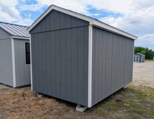 8 x 12 size painted a-roof style shed with gray siding, white trim, black architectural shingle roof, black shutters, (1) 8' ridge vent, ggs 6 foot double doors, one window.