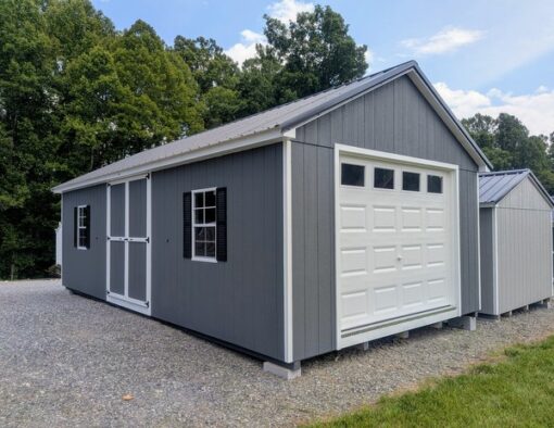 14 x 28 size painted classic garage style shed with gray siding, white trim, black metal roof, black shutters, garage door with glass, ggs 6 foot double doors 1' ft taller, two windows.