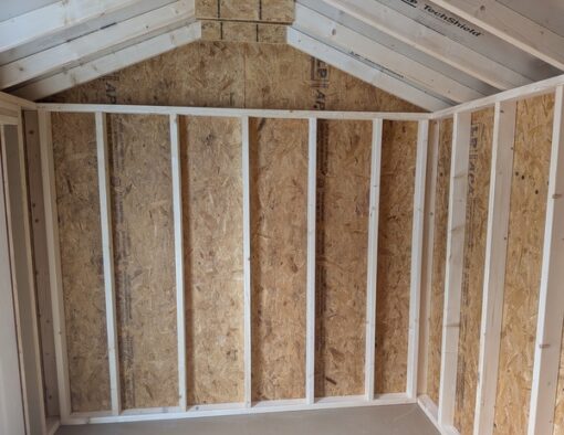 8x12 size vinyl a-roof style shed with pearl siding, white trim, black architectural shingle roof, black shutters. Has 8' ridge vent, 6 foot fiber double doors and one window.