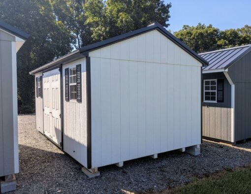 10 x 16 size painted a-roof style shed with white siding, black trim, black metal roof, black shutters, fiber solid 6 foot double doors, two windows.