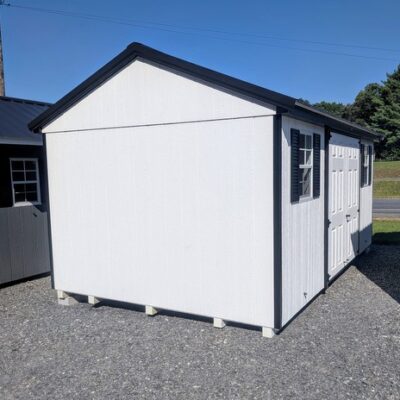 10 x 16 size painted a-roof style shed with white siding, black trim, black metal roof, black shutters, fiber solid 6 foot double doors, two windows.