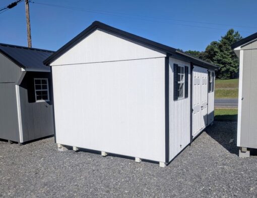 10 x 16 size painted a-roof style shed with white siding, black trim, black metal roof, black shutters, fiber solid 6 foot double doors, two windows.