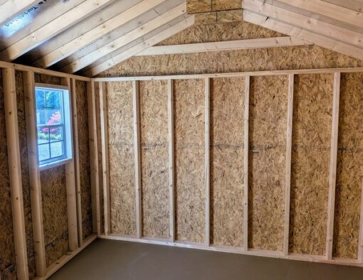 10 x 16 size painted a-roof style shed with white siding, black trim, black metal roof, black shutters, fiber solid 6 foot double doors, two windows.