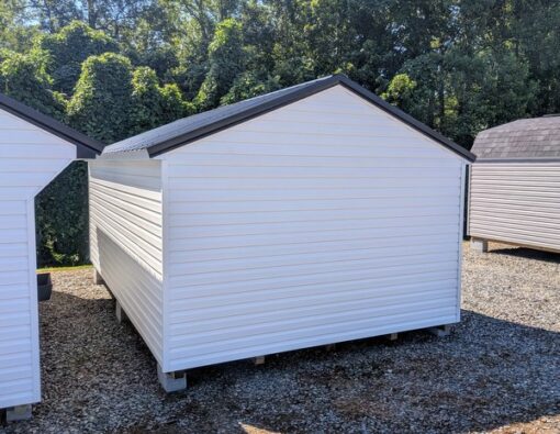 12x20 size vinyl a-roof style shed with white siding, white trim, black metal roof, black shutters. Has 6 foot fiber double doors and two windows.