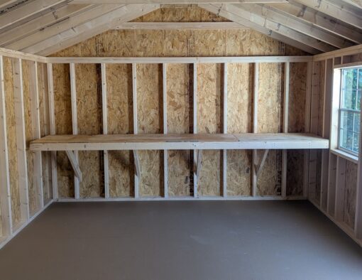 12x20 size vinyl a-roof style shed with white siding, white trim, black metal roof, black shutters. Has 6 foot fiber double doors and two windows.