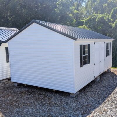 12x20 size vinyl a-roof style shed with white siding, white trim, black metal roof, black shutters. Has 6 foot fiber double doors and two windows.
