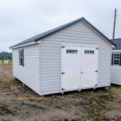 12 x 20 size vinyl classic style shed with gray siding, white trim, black metal roof, black shutters, fiber transom 6 foot double shed doors, two windows.
