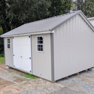 12x16 size metal classic style shed with white trim, gray metal siding, charcoal metal roof, corners and j channel, 6 foot fiber double shed doors with two windows.