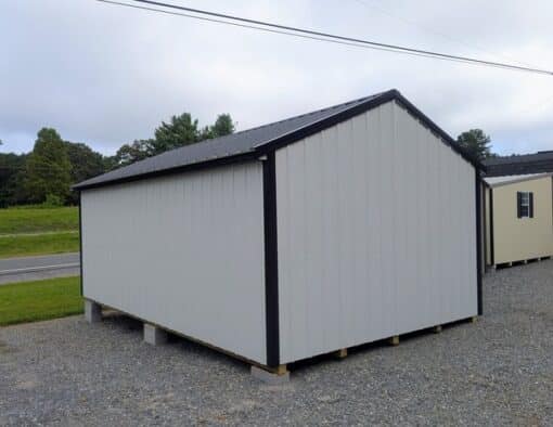12x20 size metal a-roof style shed with black trim, alamo metal siding, black metal roof, corners and j channel, 6 foot fiber double shed doors with two windows.