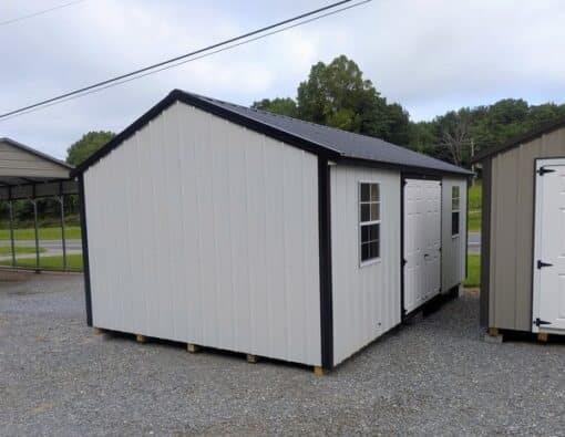 12x20 size metal a-roof style shed with black trim, alamo metal siding, black metal roof, corners and j channel, 6 foot fiber double shed doors with two windows.