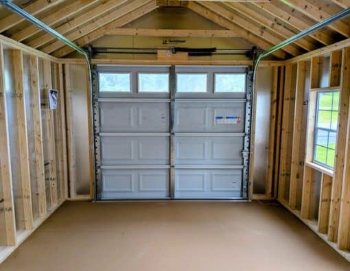 12x20 size metal classic garage style shed with white trim, charcoal metal siding, black metal roof, corners and j channel, 8x7 garage door with glass, 3 foot fiber solid shed door with two windows.