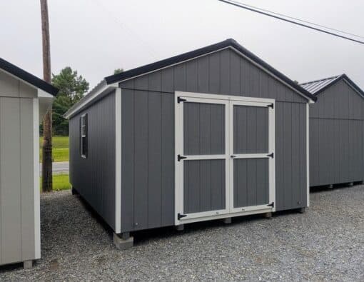 12 x 20 size painted a-roof style shed with gray siding, white trim, black metal roof, black shutters, ggs 6 foot double doors, two windows.