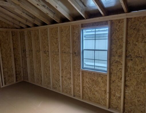 12 x 20 size painted a-roof style shed with gray siding, white trim, black metal roof, black shutters, ggs 6 foot double doors, two windows.