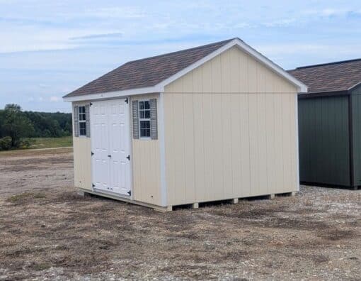 10 x 14 size painted classic style shed with navajo white siding, white trim, brownwood architectural shingle roof, clay shutters, fiber solid 6 foot double shed doors, two windows.